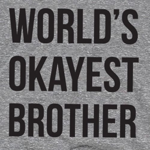 Close-up of grey T-shirt lettering: “World's Okayest Brother”