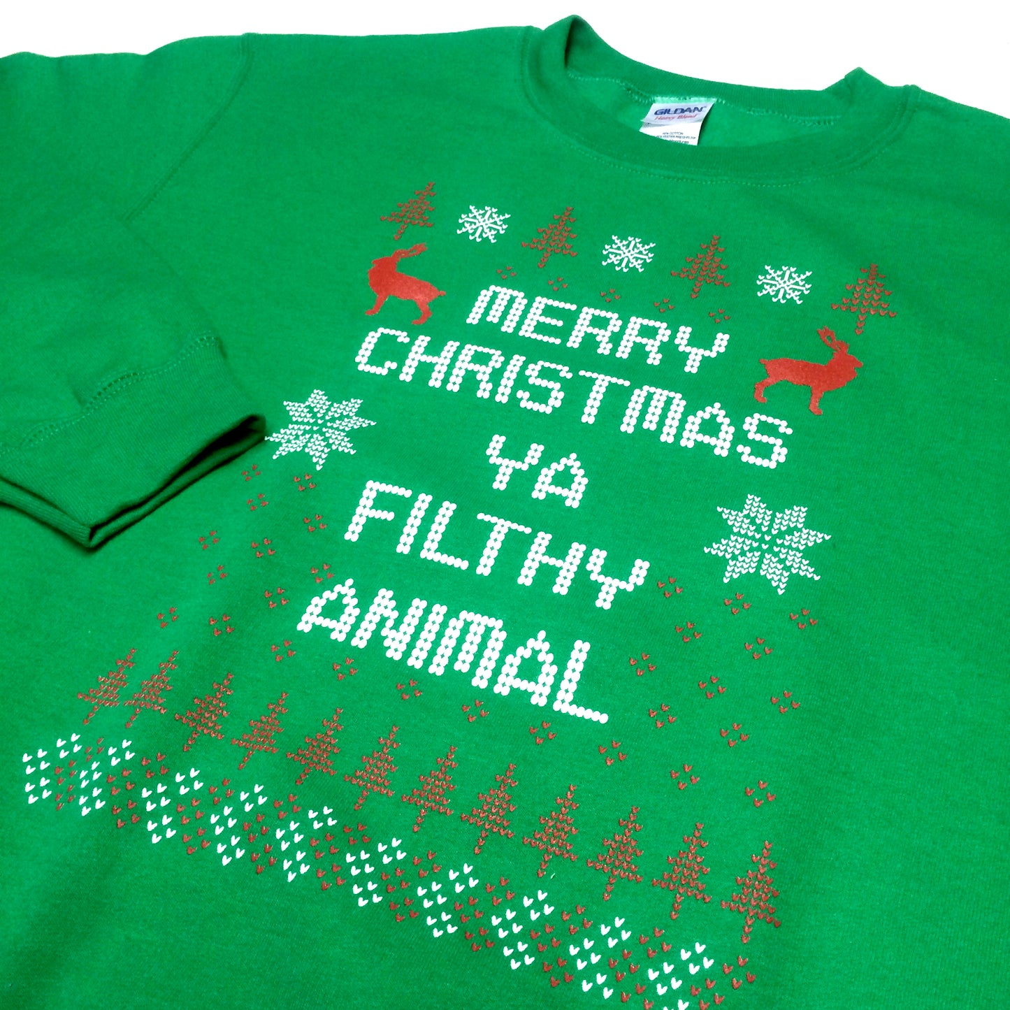 Close-up green sweater graphic: Merry Christmas Ya Filthy Animal with reindeer, snowflakes